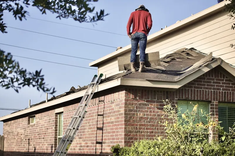 Professional roofer working on a residential roof in Lexington Woods